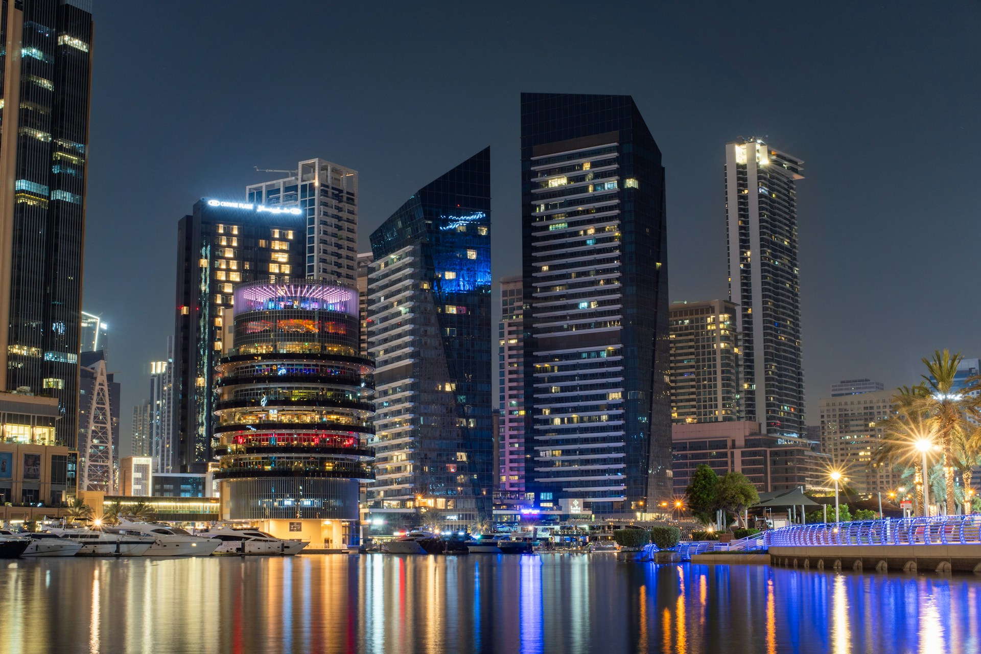 Modern city skyline at night reflected in the water